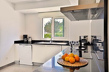A kitchen with a bottle of wine on the counter
