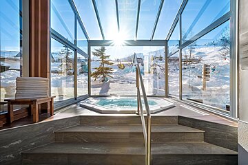 A hot tub with a view of a snowy mountain