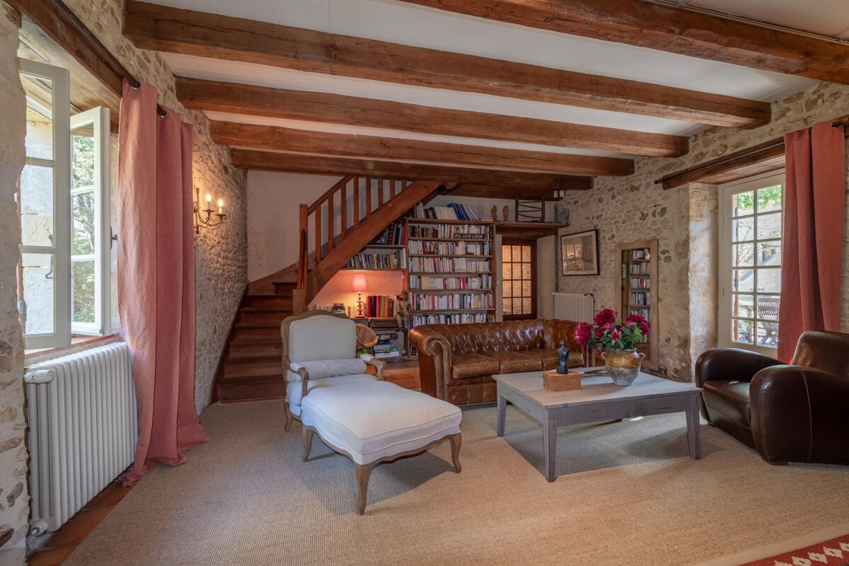 A living room with a couch a chair and a coffee table