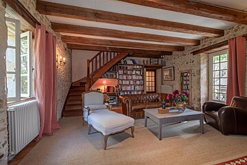 A living room with a couch a chair and a coffee table