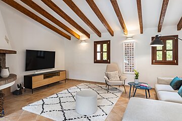 A living room with a flat screen tv on the wall