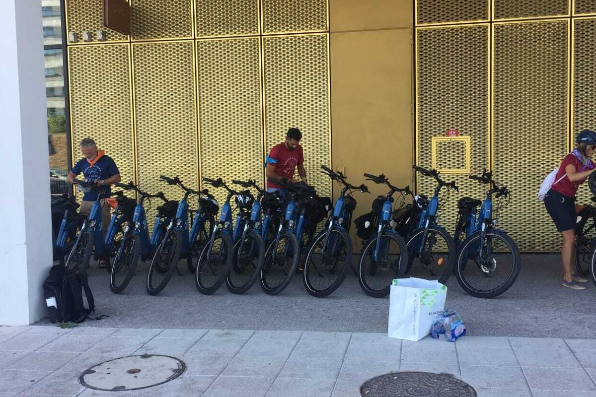 A row of bikes are parked in front of a building