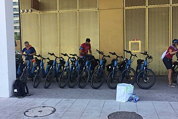 A row of bikes are parked in front of a building