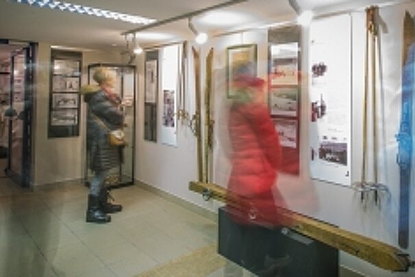 people looking at museum exhibits