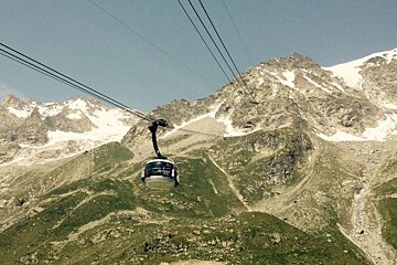 A cable car going up the side of a mountain
