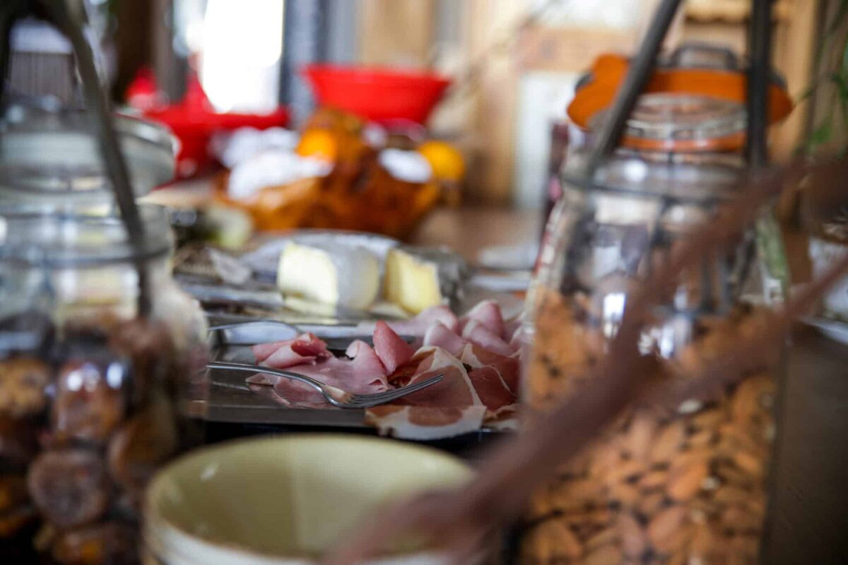 A buffet table with nuts ham and cheese