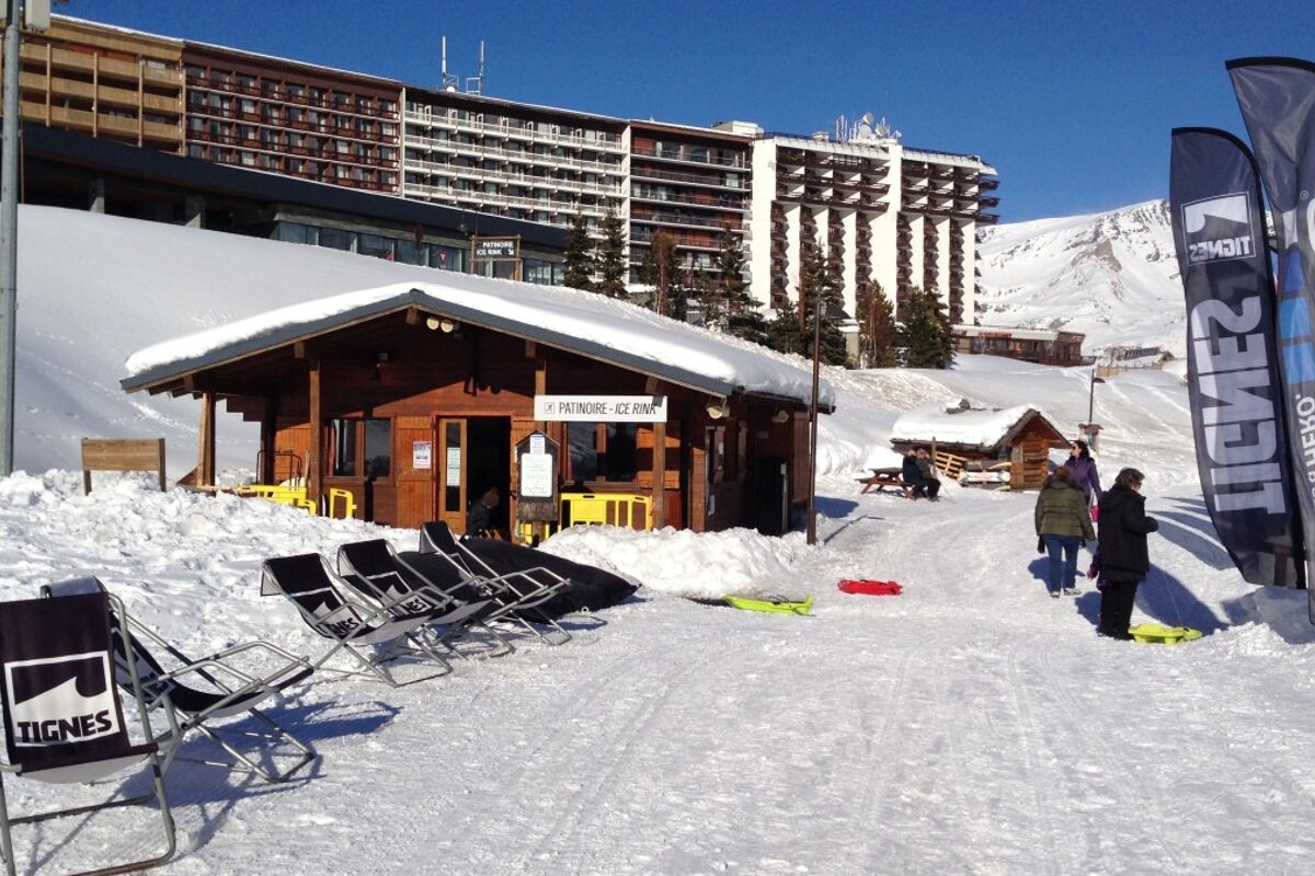 deck chairs next to a small wooden cabin
