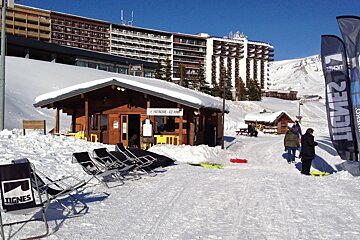 deck chairs next to a small wooden cabin