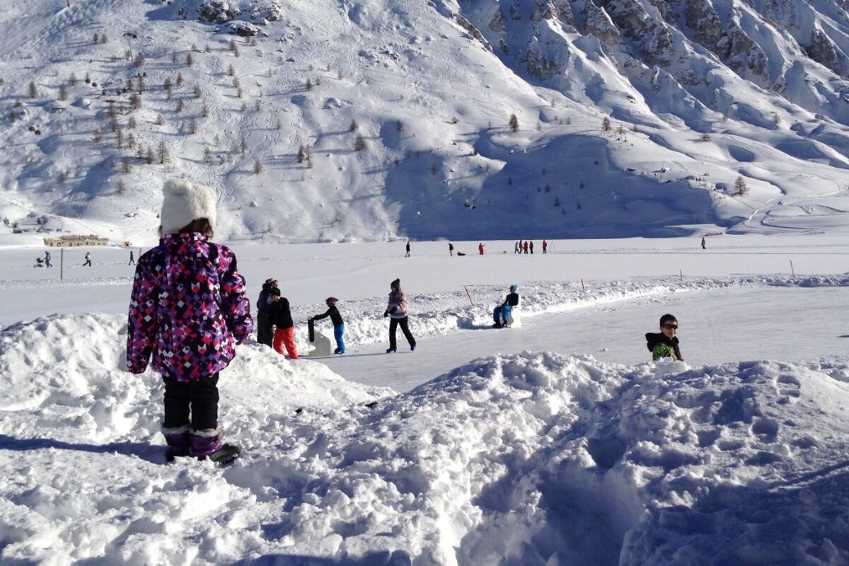 a toddler looking at the ice rink