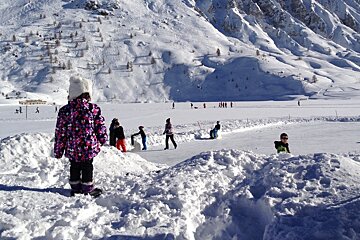 a toddler looking at the ice rink
