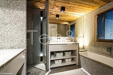 A bathroom with a bathtub and a sink with the word holidays on the bottom