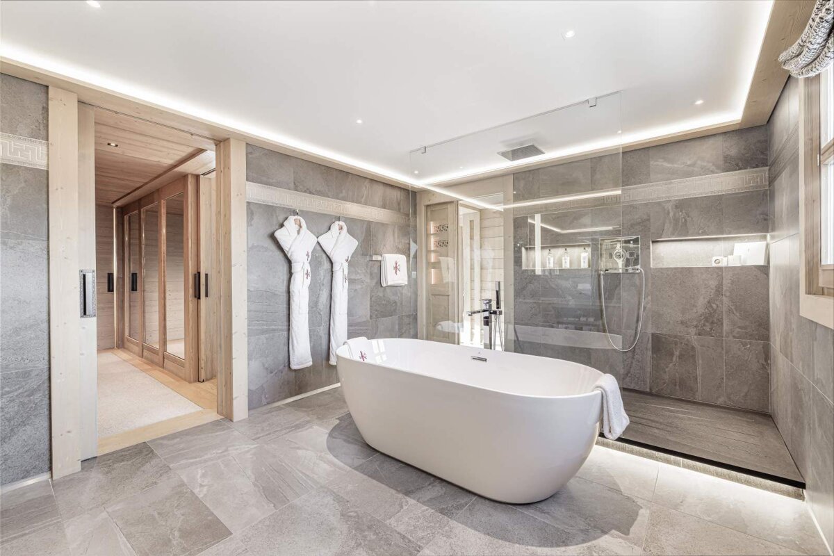 A bathroom with a bathtub and a walk in shower
