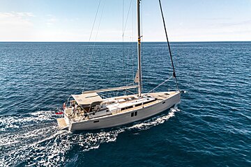 A sailboat is floating on top of a large body of water