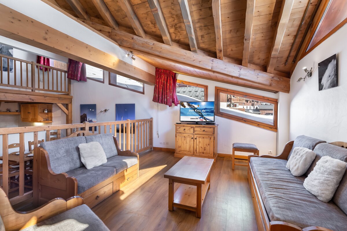 A living room with a couch and a flat screen tv