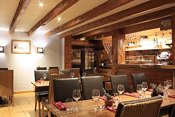 A restaurant with tables and chairs and a bar