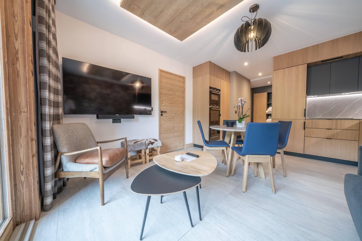 A living room with a large flat screen tv on the wall