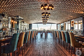 A long dining room with tables and chairs and a sign that says ' enjoy ' on it