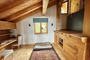 A wooden room with a rug that says ' lg ' on it