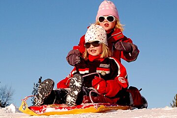 children tobogganing to win sweets