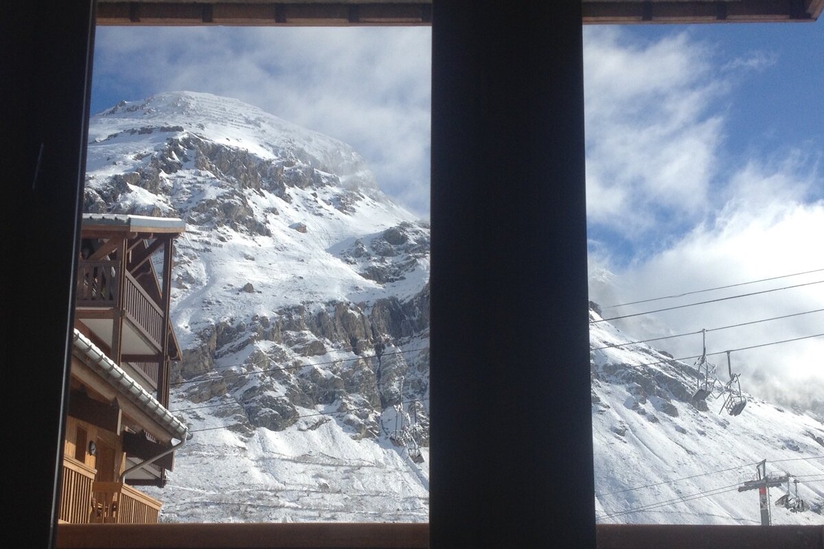 A view of a snowy mountain from a window