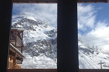 A view of a snowy mountain from a window