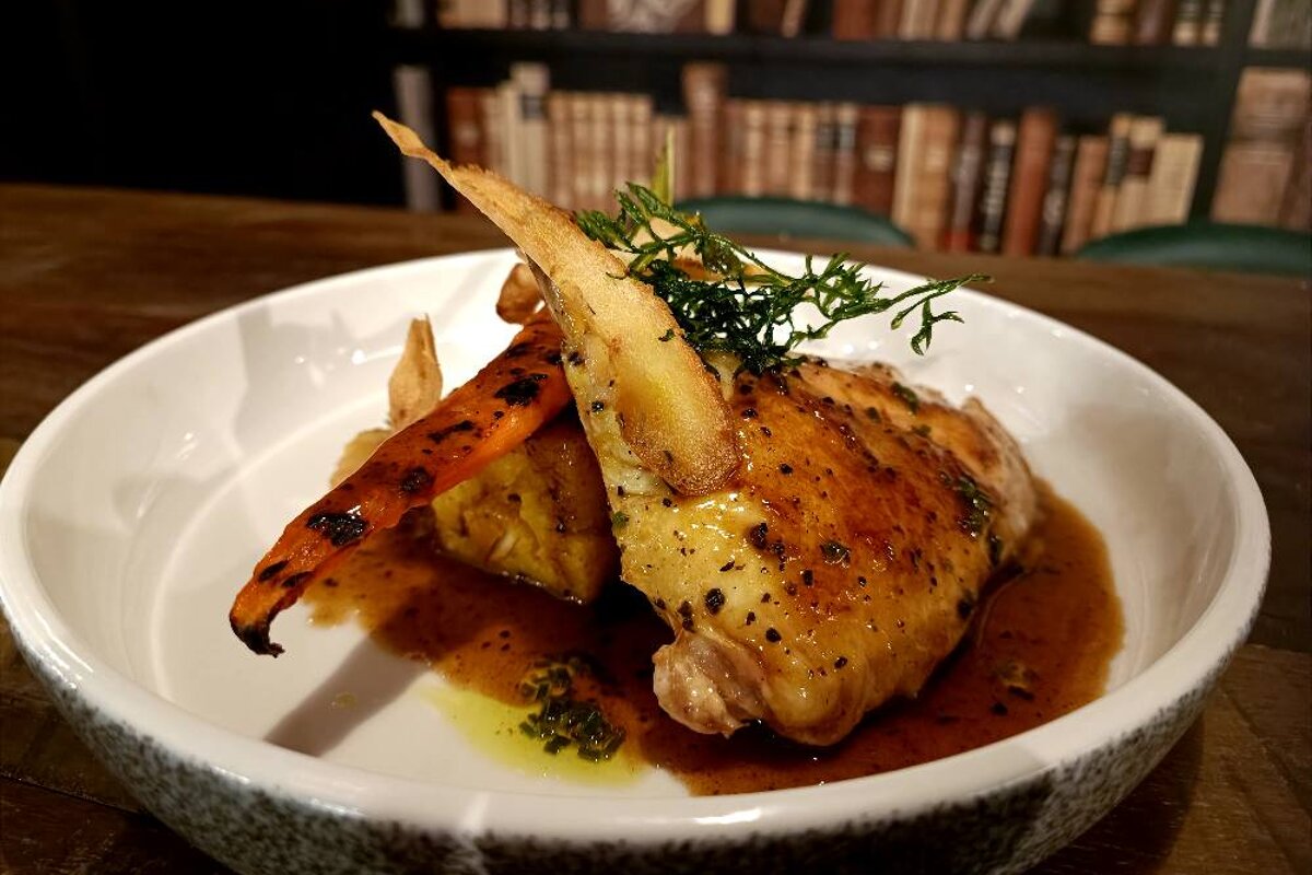 A plate of food with a bookshelf in the background