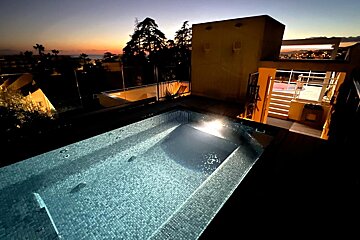 A large swimming pool is lit up at night