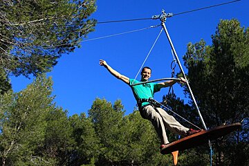 man in the trees on ropes in salon de provence