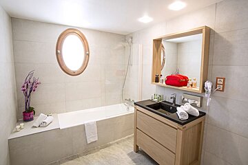 A bathroom with a bathtub and a sink
