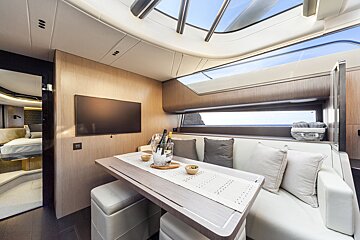 A living room with a table and a flat screen tv