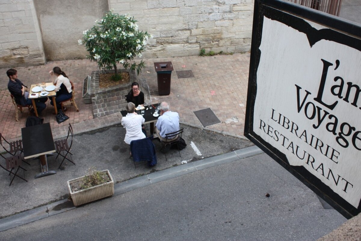 a restaurant sign hanging over the street