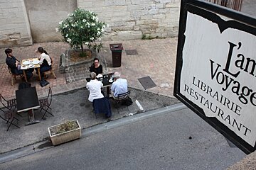 a restaurant sign hanging over the street