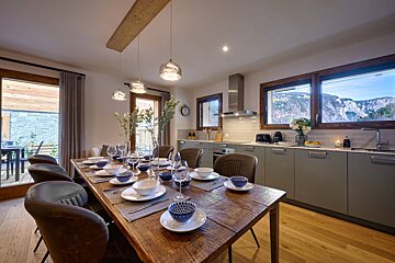 A dining room table with plates and bowls on it