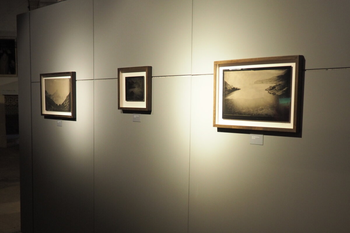 three photos on a wall in a photo exhibition