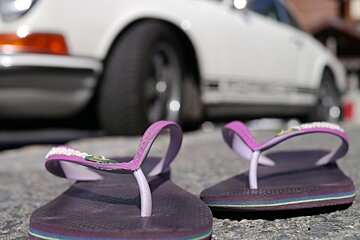flip flops in front of a porsche in Cannes