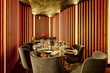 A dining room with a round table and chairs
