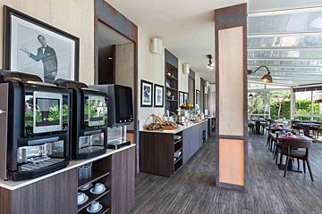 A restaurant with a picture of a man in a tuxedo on the wall