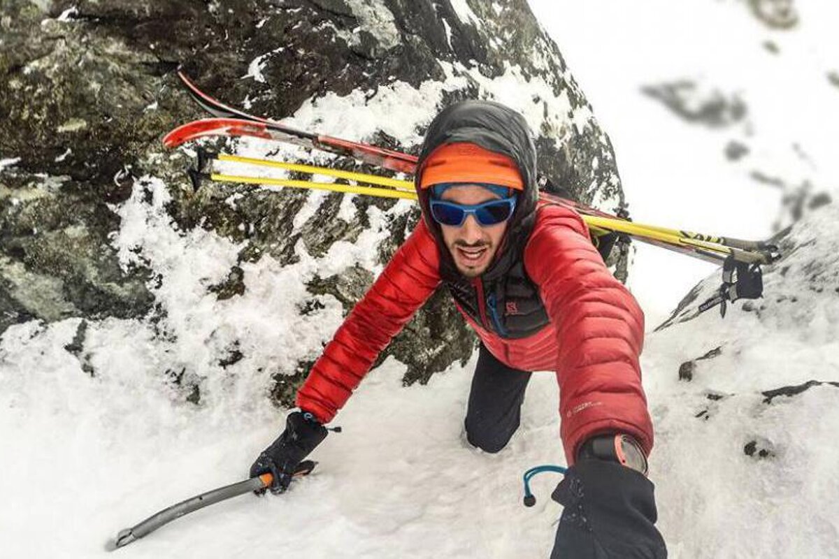 a mountaineer in a small couloir