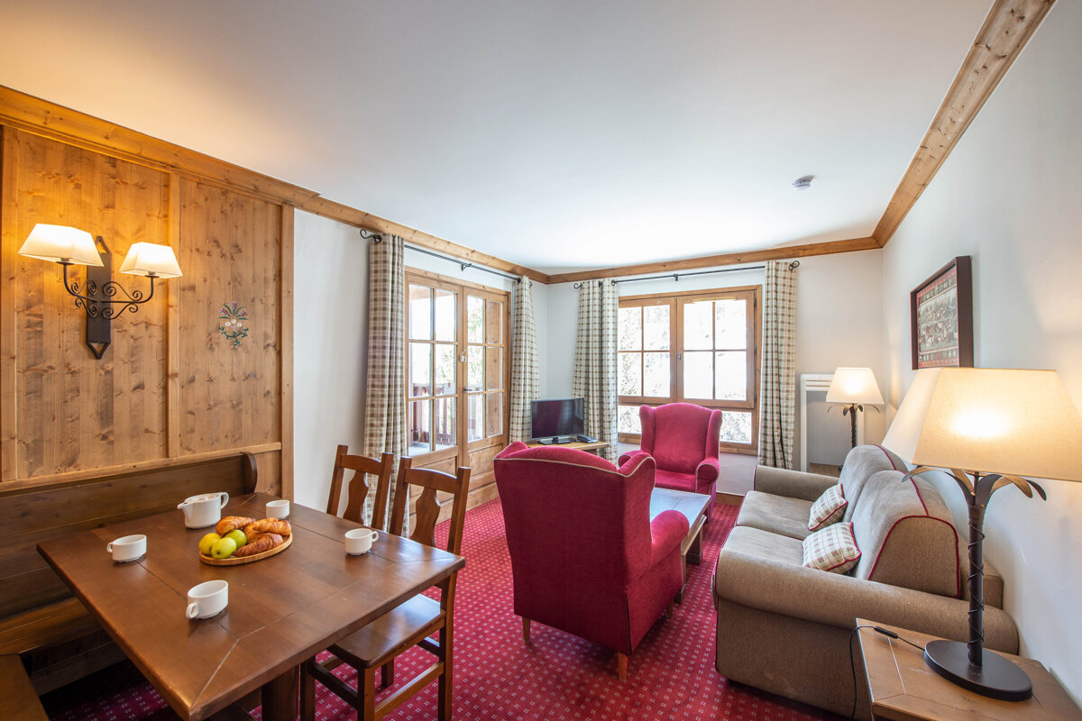 A living room with a table and chairs and a couch