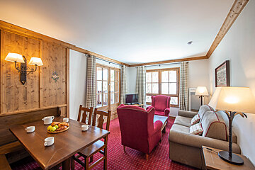A living room with a table and chairs and a couch