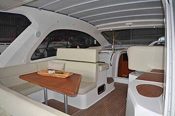 The inside of a boat with a table and chairs