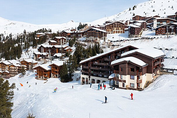 A group of people skiing down a snow covered slope