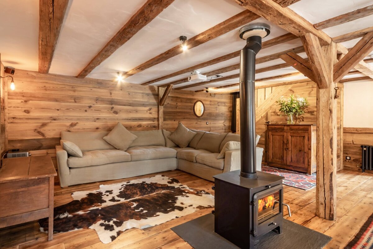 A living room with a couch and a wood stove