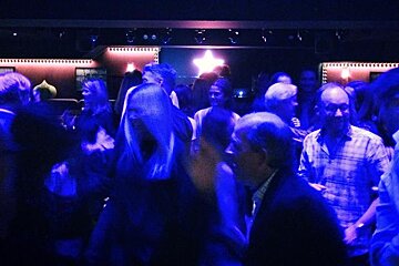 people lit by blue lights dancing