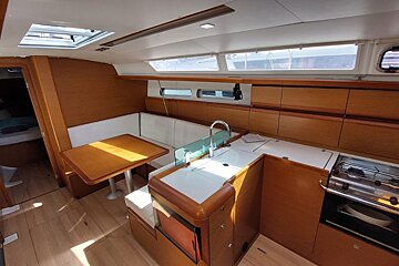 A kitchen on a boat with a sink and stove