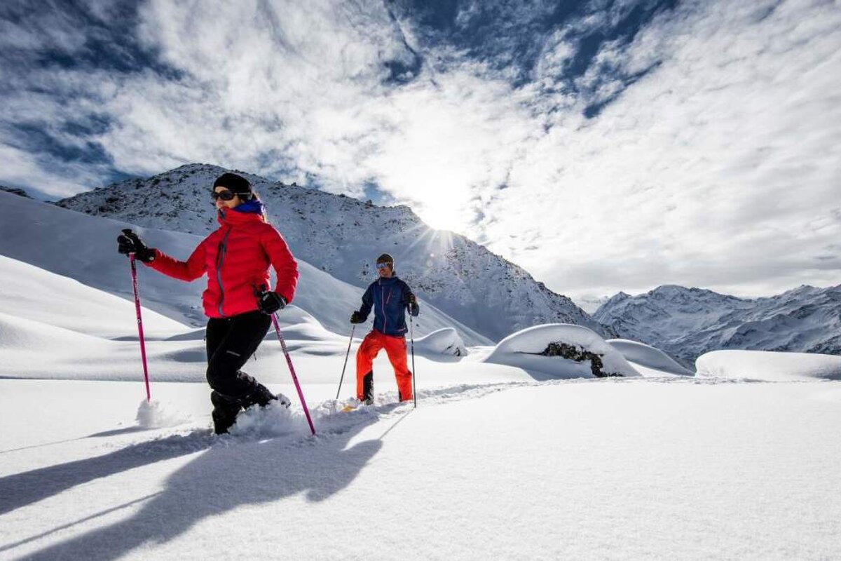 two people snowshoeing in deep powder snow