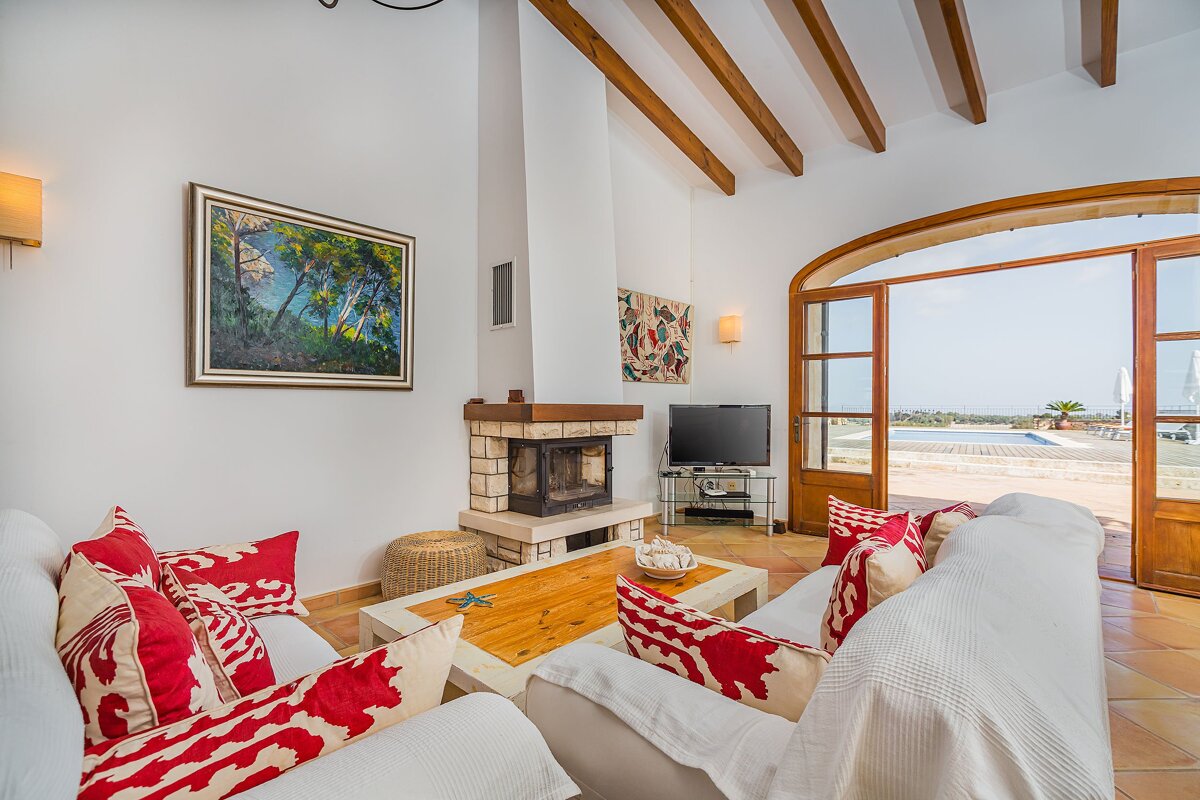 A living room with a fireplace and a television