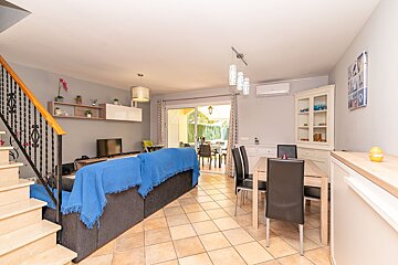 A living room with a blue blanket on the couch