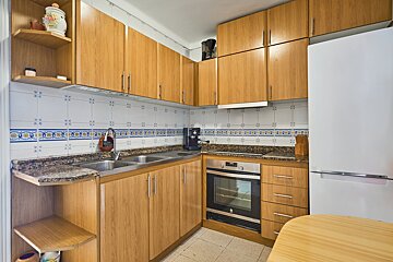 A kitchen with stainless steel appliances and wooden cabinets