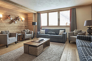 A living room with a couch that says let it snow